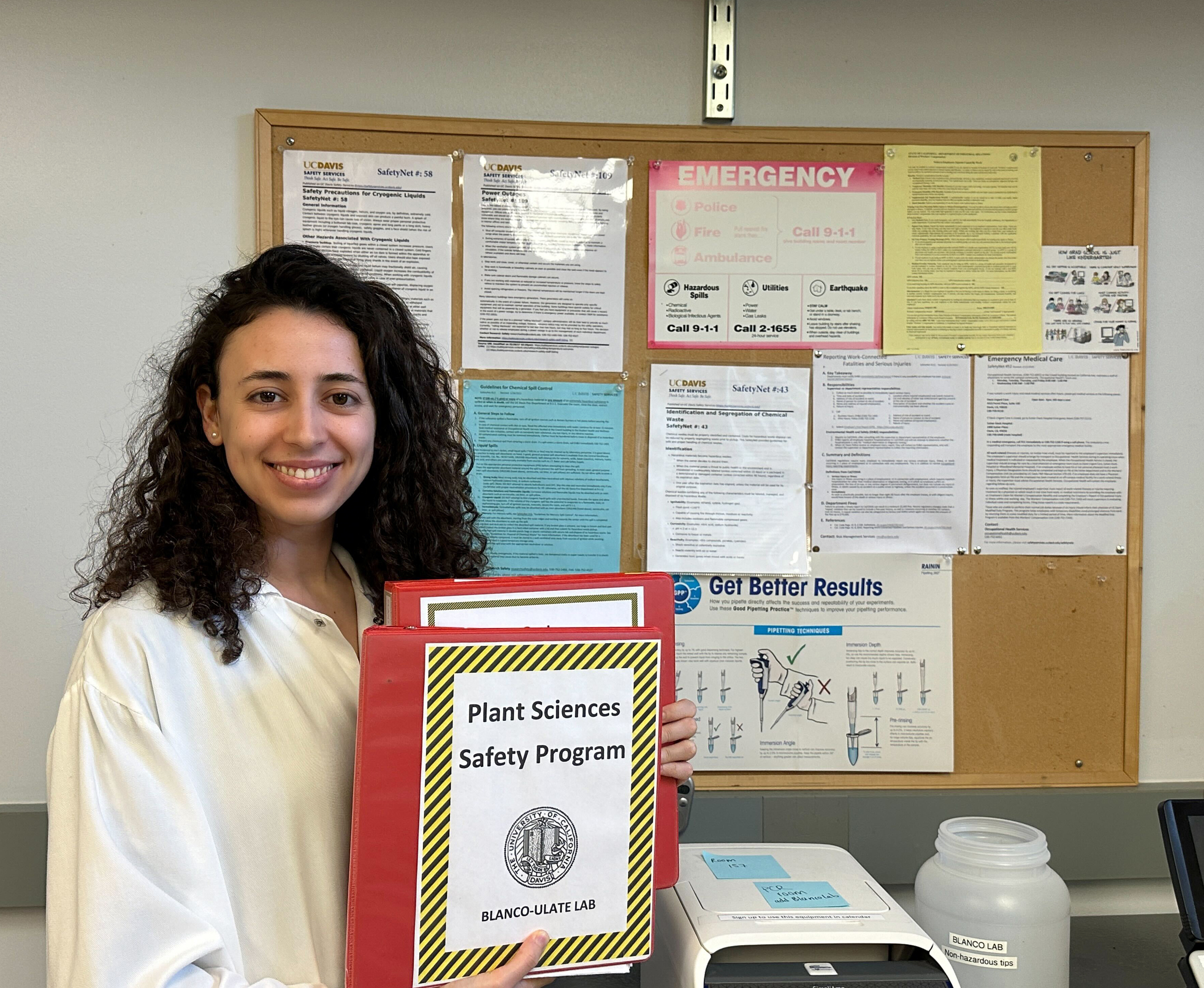 PhD candidate Sasika Mesquida-Pesci holding the Blanco-Ulate Lab Safety Manual.