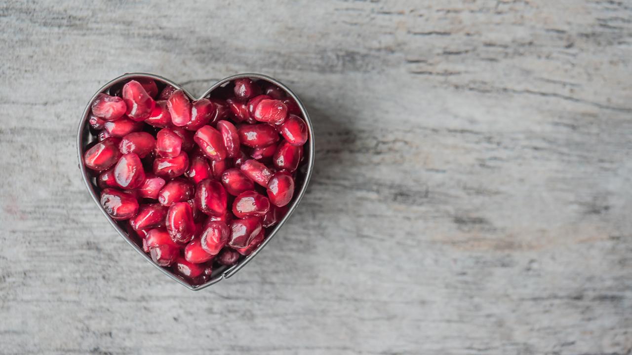 heart shape made out of pomegranate seeds