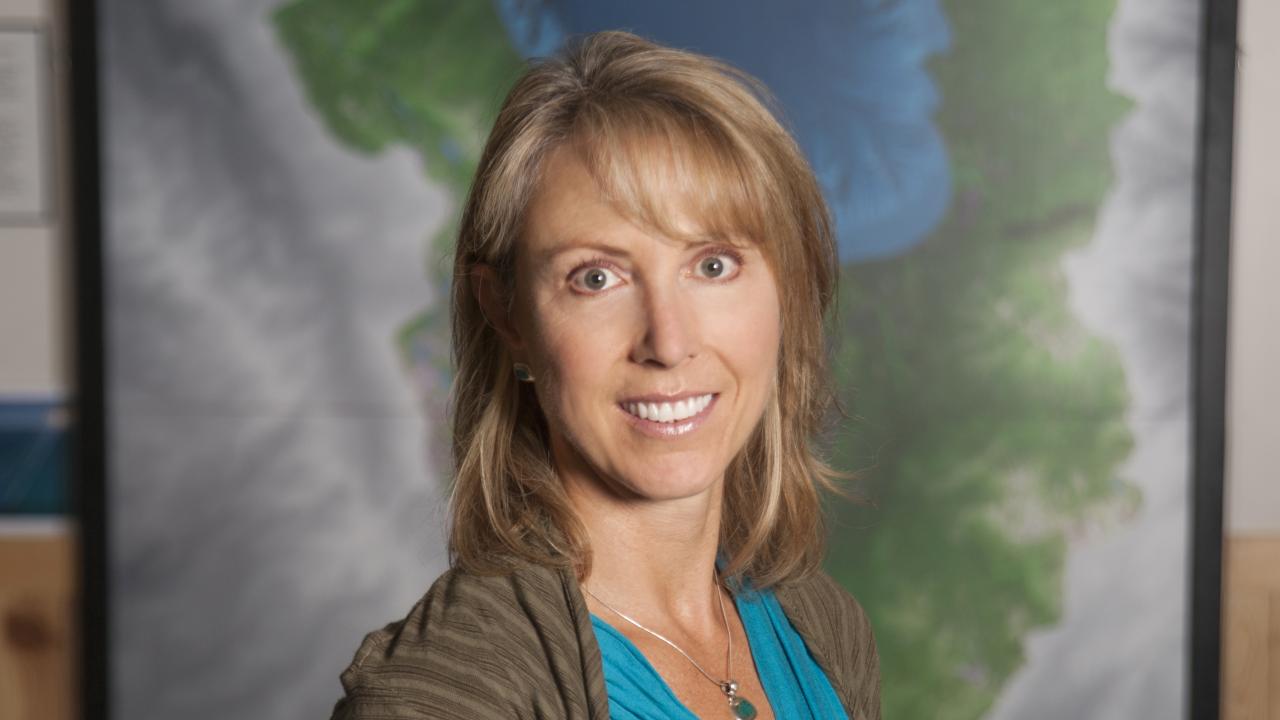 Heather Segale in front of grey, green, and blue background