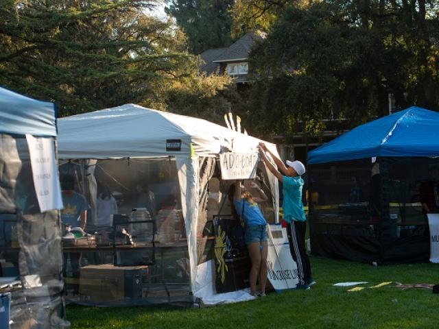 students setting up food booth on UC Davis quad.